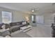 Open living room features plush carpet, neutral walls, modern furniture, and ample natural light at 11044 Spring Point Cir, Riverview, FL 33579