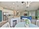 Open floor plan with modern kitchen, living room with blue couch and dining area, great for entertaining at 11044 Spring Point Cir, Riverview, FL 33579