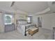Inviting main bedroom showcasing tray ceilings, plush carpet, and ample natural light, perfect for relaxation at 11044 Spring Point Cir, Riverview, FL 33579
