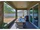 Screened outdoor dining area with a wooden table, seating for six, and views of the backyard at 11044 Spring Point Cir, Riverview, FL 33579