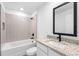 Bathroom with granite countertop vanity and shower over tub combo at 11047 Flycatcher Rd, Brooksville, FL 34614