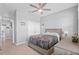 Bedroom with ceiling fan, tiled floors, and lots of natural light at 11295 Timber Grove Ln, Brooksville, FL 34613