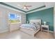 Primary bedroom with large window and teal accent wall at 11295 Timber Grove Ln, Brooksville, FL 34613
