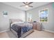 Bedroom with ceiling fan, tiled floors, and lots of natural light at 11295 Timber Grove Ln, Brooksville, FL 34613