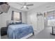 Bedroom with ceiling fan, tiled floors, and large closet at 11295 Timber Grove Ln, Brooksville, FL 34613