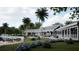 Stunning clubhouse exterior with well manicured lawn, gorgeous tropical flowers, and mature palm trees at 11295 Timber Grove Ln, Brooksville, FL 34613