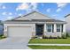 Charming single-story home featuring a manicured lawn and attached two-car garage at 11295 Timber Grove Ln, Brooksville, FL 34613