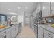 Modern kitchen features granite counters, stainless appliances, and ample cabinet space at 11295 Timber Grove Ln, Brooksville, FL 34613