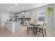 Bright eat-in kitchen boasts gray cabinetry, granite countertops, stainless appliances, and tile flooring at 11295 Timber Grove Ln, Brooksville, FL 34613