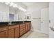 Bathroom featuring double vanity, large mirror, and glass enclosed shower at 11317 Wickersley Pl, Tampa, FL 33625