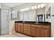 Bathroom features double vanity, granite countertops, and a glass-enclosed shower at 11317 Wickersley Pl, Tampa, FL 33625