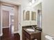 A bathroom with a granite sink and access to the hall at 11317 Wickersley Pl, Tampa, FL 33625