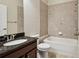 A bathroom featuring a granite countertop and tiled bathtub with shower at 11317 Wickersley Pl, Tampa, FL 33625