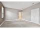 Neutral-toned carpeted bedroom features natural light, closet and entry door at 11317 Wickersley Pl, Tampa, FL 33625