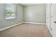 A carpeted bedroom with neutral walls and a window providing natural light at 11317 Wickersley Pl, Tampa, FL 33625