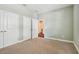 A carpeted bedroom with access to the home's hallway at 11317 Wickersley Pl, Tampa, FL 33625