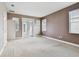 Bedroom with two large windows, sliding door, and neutral walls and carpet at 11317 Wickersley Pl, Tampa, FL 33625