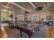 Interior of a clubhouse with a billiards table, seating areas, and exterior views at 11317 Wickersley Pl, Tampa, FL 33625