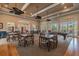 Interior of a clubhouse with tables, chairs, billiards table, hardwood floors, and recessed lighting at 11317 Wickersley Pl, Tampa, FL 33625