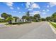 Elegant stone community entrance sign 'Ravinia', complemented by palm trees and lush landscaping at 11317 Wickersley Pl, Tampa, FL 33625