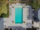 Aerial view of the rectangular community pool, surrounded by lounge chairs, and lush landscaping at 11317 Wickersley Pl, Tampa, FL 33625