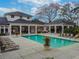 Aerial view of a large community pool with ample seating and covered outdoor dining areas at 11317 Wickersley Pl, Tampa, FL 33625