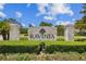 Stone community sign reading 'Ravinia' with manicured hedges in a tranquil setting at 11317 Wickersley Pl, Tampa, FL 33625