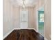 Welcoming foyer boasting hardwood floors, white trim, and a glimpse into a bright room at 11317 Wickersley Pl, Tampa, FL 33625