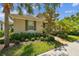 Beautiful home featuring tropical landscaping, a brick path, and a welcoming exterior at 11317 Wickersley Pl, Tampa, FL 33625