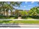 Charming home featuring a lush landscaped yard, brick walkway, and covered entry at 11317 Wickersley Pl, Tampa, FL 33625