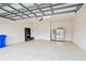 Spacious two car garage with speckled flooring, water heater, and storage at 11317 Wickersley Pl, Tampa, FL 33625
