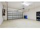 A two car garage featuring speckled flooring and an automatic door opener at 11317 Wickersley Pl, Tampa, FL 33625