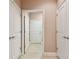 Hallway with multiple white doors and trim offers natural light and access to other rooms at 11317 Wickersley Pl, Tampa, FL 33625