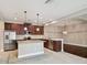 Kitchen featuring granite countertops, a central island, and stainless steel appliances at 11317 Wickersley Pl, Tampa, FL 33625