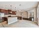 Open kitchen with stainless steel appliances, granite countertops, and a central island at 11317 Wickersley Pl, Tampa, FL 33625