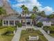 Elegant community center with a covered porch, walkway, mature palms, and meticulous landscaping at 11317 Wickersley Pl, Tampa, FL 33625