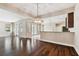 Open-concept living room with hardwood floors and seamless access to the kitchen and outdoor areas at 11317 Wickersley Pl, Tampa, FL 33625