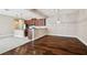 Open floor plan with hardwood floors connecting a living area to a kitchen with granite countertops at 11317 Wickersley Pl, Tampa, FL 33625