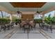 Outdoor kitchen and dining area with stainless steel grills, ceiling fans, and seating for community gatherings at 11317 Wickersley Pl, Tampa, FL 33625