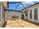 This outdoor patio has a geometric screen, brick floors, and a planter at 11317 Wickersley Pl, Tampa, FL 33625