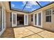 A brick patio with an open door to the interior of the home at 11317 Wickersley Pl, Tampa, FL 33625