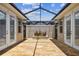 This outdoor patio has a geometric screen, brick floors, and a planter at 11317 Wickersley Pl, Tampa, FL 33625