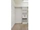Walk-in closet with white shelving units and ample storage space at 11317 Wickersley Pl, Tampa, FL 33625