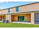 A covered back patio with sliding glass doors and a grassy yard offers serene outdoor living at 12710 Buffalo Run Drive, Gibsonton, FL 33534