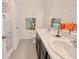 Bright bathroom with double sinks, a large mirror, and a shower with blue sea-themed curtains at 12710 Buffalo Run Drive, Gibsonton, FL 33534
