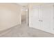 Bedroom with neutral carpet, a double door closet, and an open door to the hallway at 12710 Buffalo Run Drive, Gibsonton, FL 33534