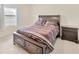 Comfortable bedroom featuring a queen bed with purple comforter and wood accents at 12710 Buffalo Run Drive, Gibsonton, FL 33534