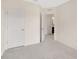 Bedroom with neutral carpet, a double door closet, and an open door to an ensuite bathroom at 12710 Buffalo Run Drive, Gibsonton, FL 33534