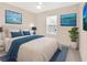 Relaxing bedroom with blue accents, neutral walls, and bright natural light at 12710 Buffalo Run Drive, Gibsonton, FL 33534