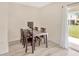 Cozy dining area with dark wood table and chairs, and access to the outdoor patio at 12710 Buffalo Run Drive, Gibsonton, FL 33534
